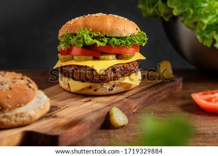 burger on the board on a dark background