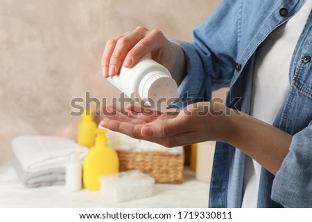 Mom applying talc powder from plastic tube. Baby hygiene Royalty-Free Stock Photo #1719330811
