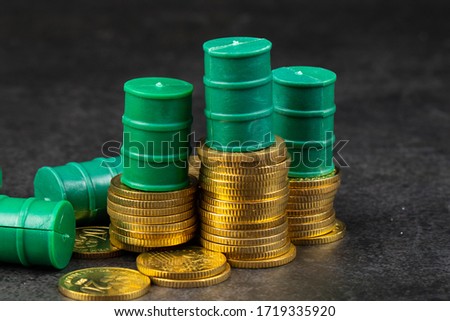 Stack Image of Coins with oils barrel. Crude oil commodity trading in price crisis situation.