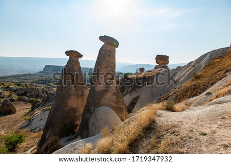 Rocks looking like mushrooms dramatically  in Cappadocia, Turkey This photo was shot from Cappadocia which located in the center of Turkey. Cappadocia is an ancient region of Anatolia. 