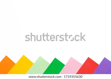 Colorful paper blocks on white background isolated.  Orange, yellow, green, mint, pink, red, violet colors. Copy space for your text and design. Flat lay top view
