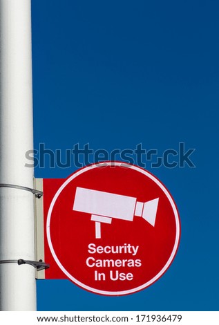 Red Security Cameras in Use Sign in American Mall Parking Lot in Vertical