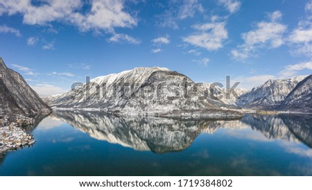 Aerial drone shot of snow covered hill with reflection by Hallst