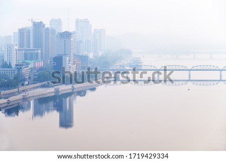 Skyline and Taedong River in the morning fog. View from the Yanggakdo island Royalty-Free Stock Photo #1719429334