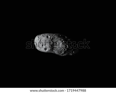 large asteroid with many craters in space 