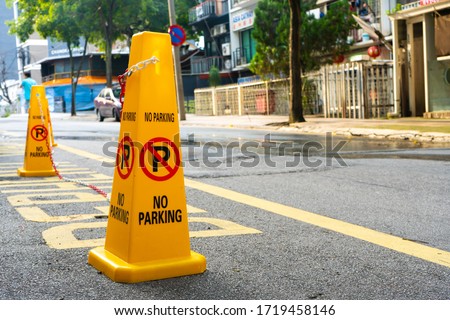 Plastic yellow cones forbidding parking nearby