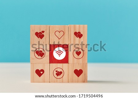 Square of wooden cubes with hearts and wifi signs. Online dating. Virtual communication and relationship, copy space