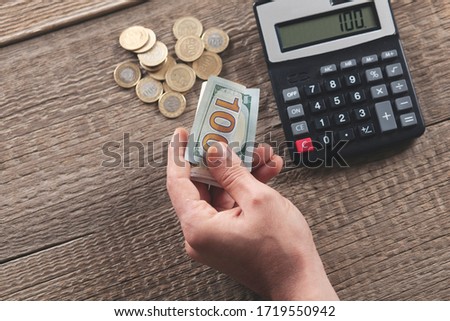 man hand money with calculator on desk
