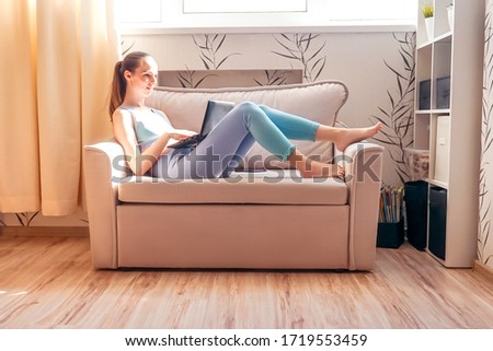 Fitness woman use laptop in sofa after training.