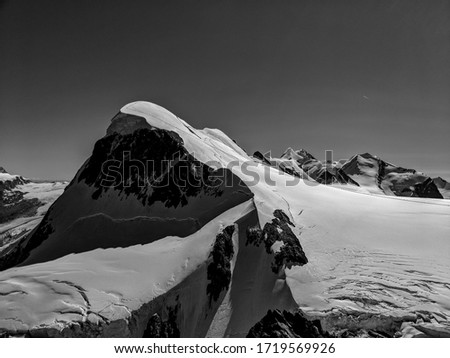Black and White Photography of a Snowy peak at high altitude, in the Swiss Alps