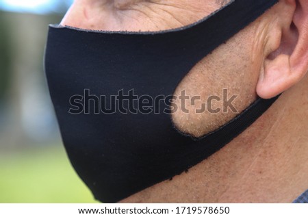 
Medicine, profession and healthcare concept - an asian doctor, medical staff or scientist wearing a protective face mask on gray background