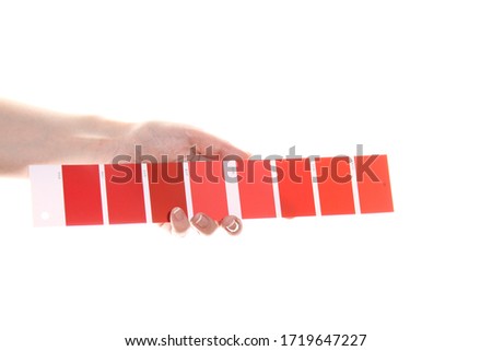Woman hand holds a red color palette. Isolated on white background