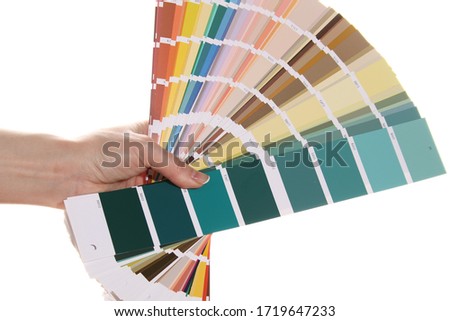 Woman hand holds a color palette. Isolated on white background