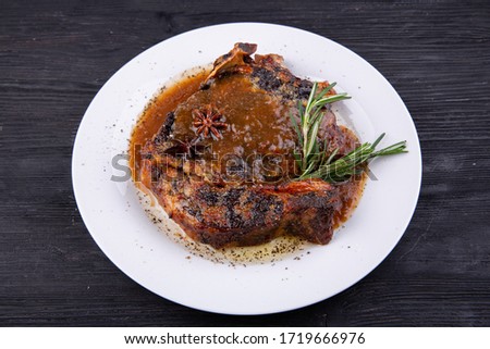 Fried pork meat baked in an oven with sauce and spices
