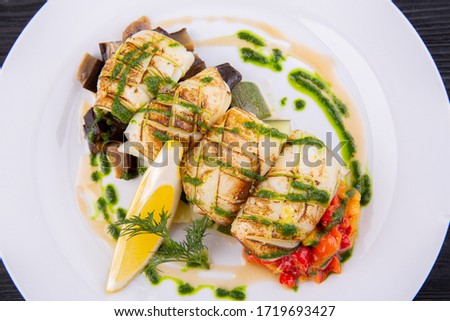Grilled squid with stewed vegetables and greens