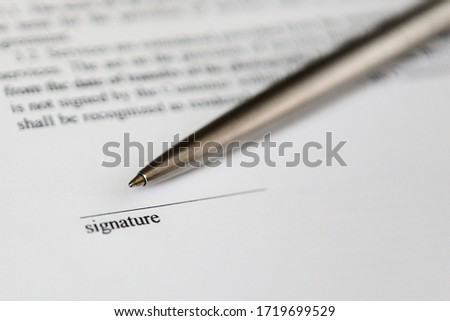 Space for signature on document and silver boll pen