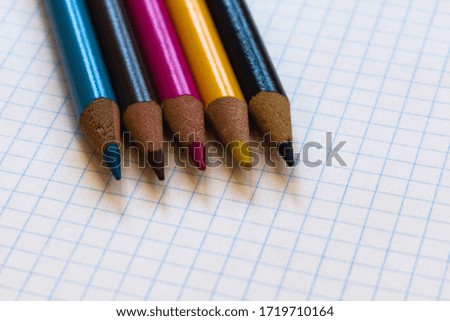 color pencils and notebook on the table