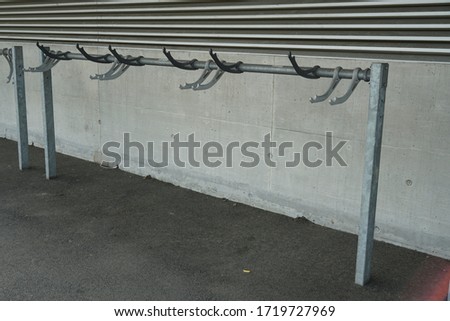 Parking place or rack for bicycles in detail or close up in a residential area in a Swiss town a solution that supports mobility and sport without negative impact on the environment