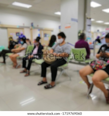 Blurred abstract background of patients who come to the hospital, waiting to see a doctor .. sitting spaced between people to stop the spread of the virus Covid-19