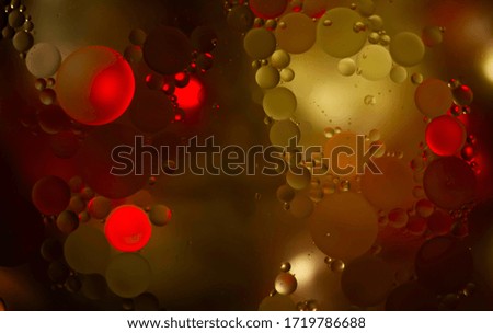 Red glitter vintage lights background. Red and yellow texture background. Oil in water.