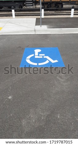 Blue and White Handicap Symbol on Pavement