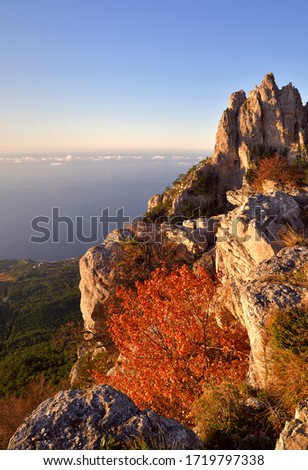 The top of mount AI-Petri in the early morning. Sharp rocks, clouds on the horizon below, clear sky. Tourist attraction, no people, a place to text.   Royalty-Free Stock Photo #1719797338