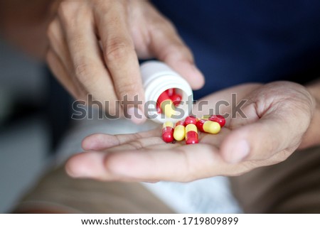 Medicine and health care concept. Man holding medicine capsules in hand. Healthy lifestyle, nutritional supplements