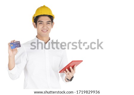 Isolation with clipping path. Asian foreman holding a mock up credit card and showing in front of himself with copy space. Asian engineer wearing a safety yellow helmet portrait on white background.
