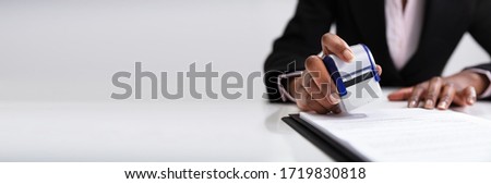 Public Notary Putting Company Stamp On Contract At Office Desk  Royalty-Free Stock Photo #1719830818