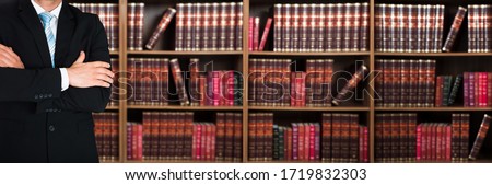 Legal Advisor And Lawyer With Crossed Arms Against Books