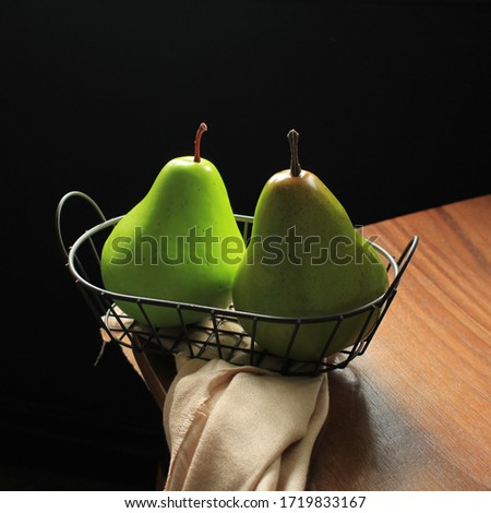 Two Pear on a Basket with Dark Background
