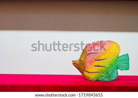 Wooden fish on a white background. Handmade carved from wood. An original souvenir for the fisherman.