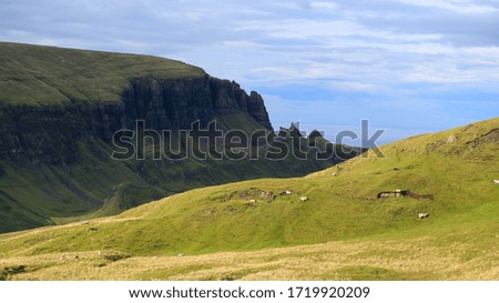 The undulating landscape of the northern tip of the Isle of Skye on the Quiraing, Trotternish; looking towards the mainland across the lush landscape at dusk