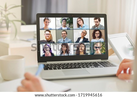 Online conference of colleagues through a laptop. Video call for training. Educational webinar chat between different people. Team meeting. Royalty-Free Stock Photo #1719945616