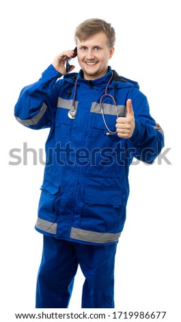 Medic in overalls with a phone. Ambulance, specialist smiles and shows the class. doctor, ambulance, paramedic. isolated.