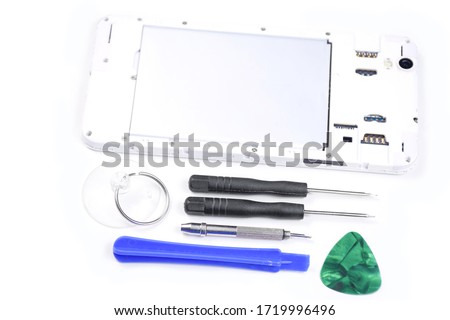 Cell phone with a broken screen on a white background. Repair of a cell phone with a broken screen in the service with a special tool. Cell Phone Repair Tool