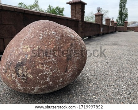 Big stone on dry asphalt 
