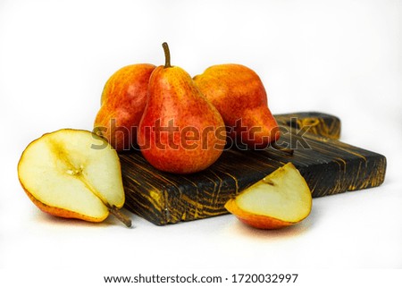 Ripe red yellow Pear fruits on wooden cutting Board isolated on white background