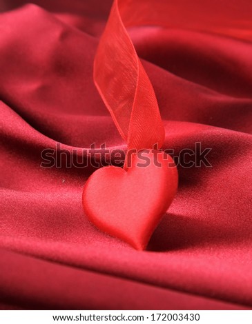 Invitation card on red silk satin background