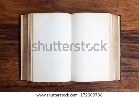 Vintage book, open, on old wooden table. Royalty-Free Stock Photo #172003736