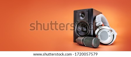 Musical equipment on an orange background. Close-up