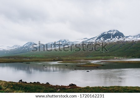 Landscapes of mountains covered with snow. The lake in the middle of the mountains.
