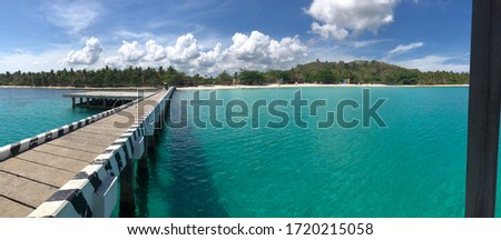 clear sunny summer sky with clouds on a whitesand beach resort called Malamawi Island in the province of Basilan Philippines