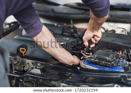 Man master repairs under the hood of the car. Repairing concept
