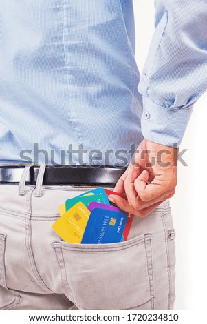 Faceless photo of a man taking out many credit cards out of his pocket, isolated on white background