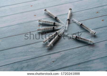 Syringe on wooden table in selective focusing