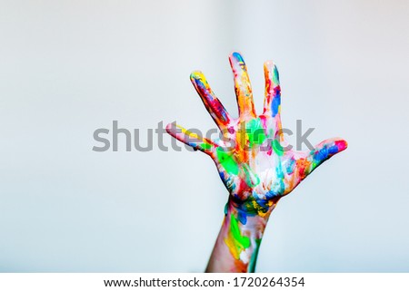 Colourful child's painted hand up on the white background Royalty-Free Stock Photo #1720264354