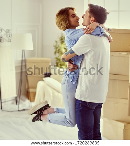 Photo of a happy young couple hugging and celebrating that they bought a house