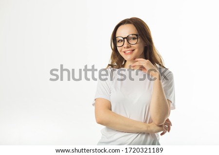 beautiful young woman in a white t-shirt on a white background Royalty-Free Stock Photo #1720321189