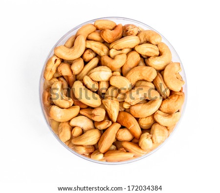 Cashew nuts in glass blow on white background